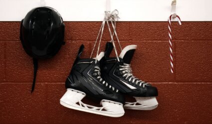 hockey skates hanging between helmet and candy cane